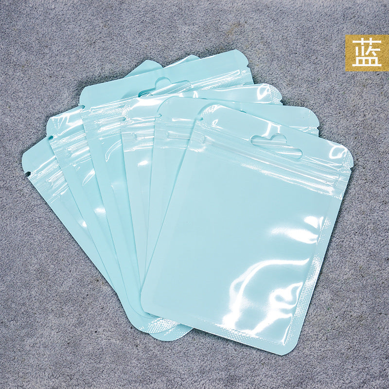 A Macaron color self-sealing bag, holographic bag, thickened transparent color bone bag, jewelry, sealed pocket, makeup brush, packaging bag.
