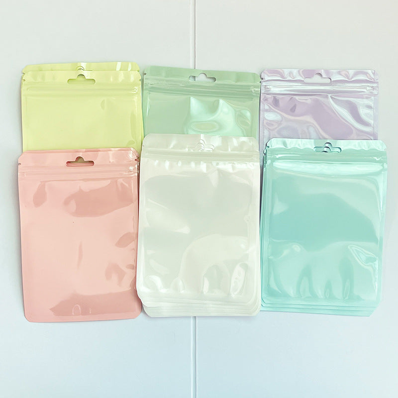 A Macaron color self-sealing bag, holographic bag, thickened transparent color bone bag, jewelry, sealed pocket, makeup brush, packaging bag.