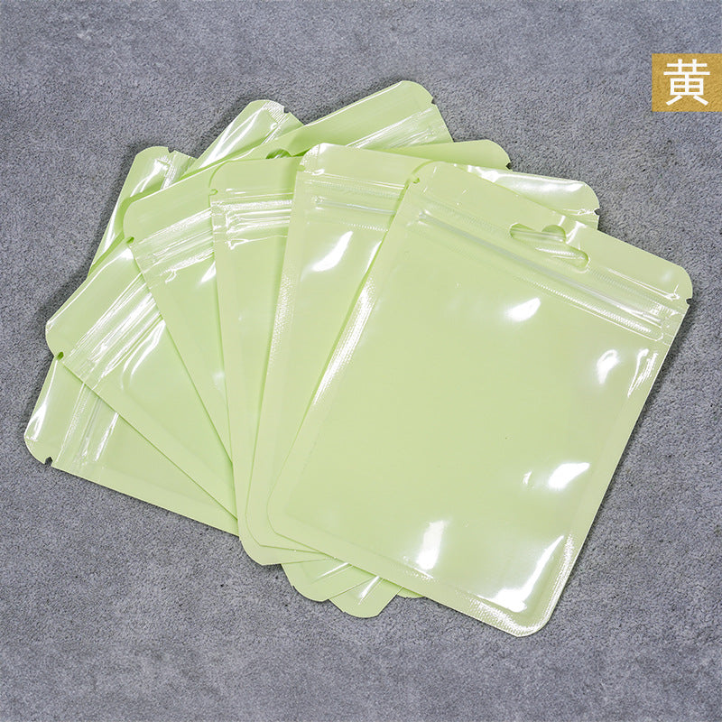A Macaron color self-sealing bag, holographic bag, thickened transparent color bone bag, jewelry, sealed pocket, makeup brush, packaging bag.
