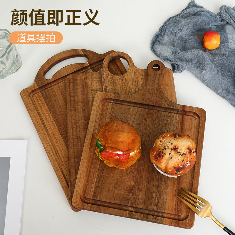 A Acacia wood pizza tray with handle solid wood cheese bread tray household steak plate, creative wooden small cutting board