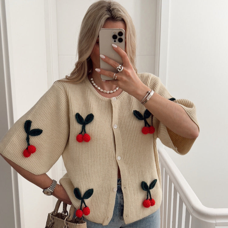 A cherry garnish sweater