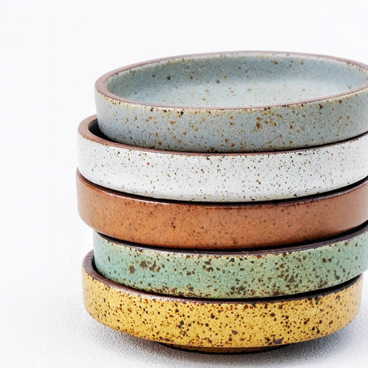 A rough pottery dipping sauce dish