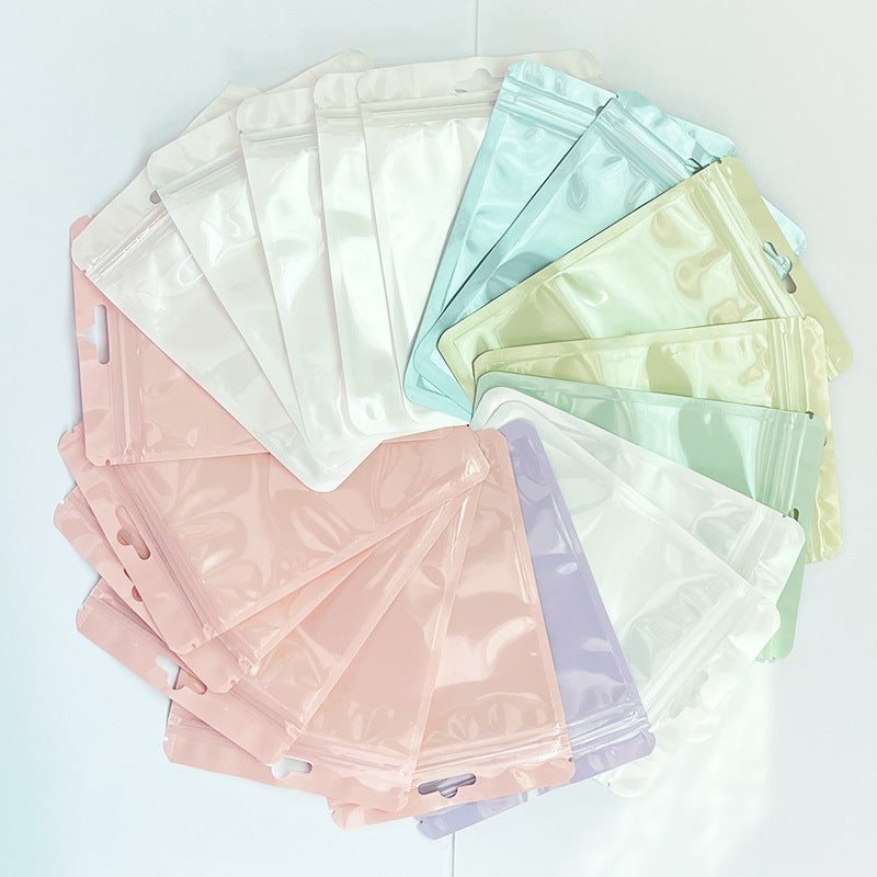 A Macaron color self-sealing bag, holographic bag, thickened transparent color bone bag, jewelry, sealed pocket, makeup brush, packaging bag.
