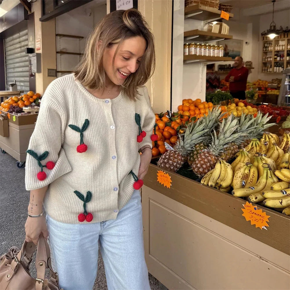 A cherry garnish sweater