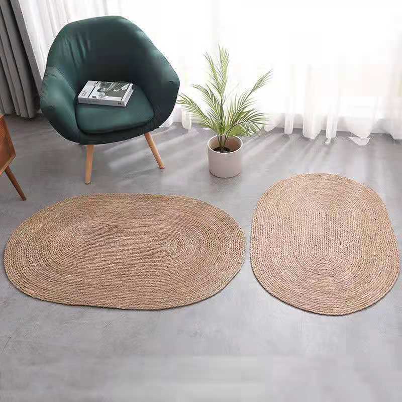 A handmade grass rattan woven carpet floor mat
