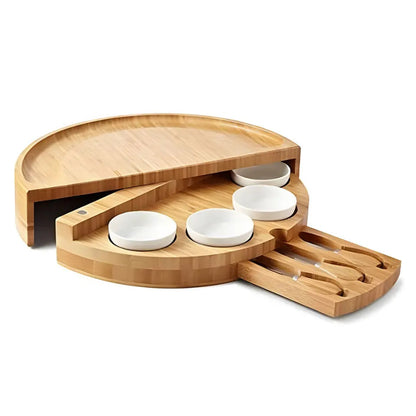 A bamboo and wood cheese board cheese board wooden round rotatable cutting board with drawer small bowl knife and fork set