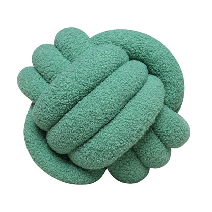 A braided knotted ball pillow