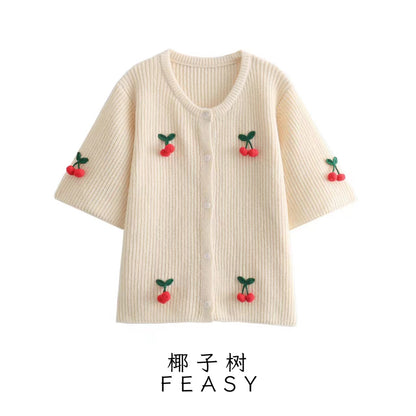 A cherry garnish sweater