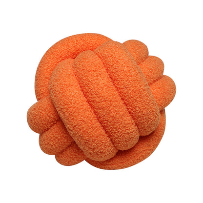 A braided knotted ball pillow