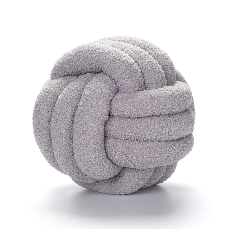 A braided knotted ball pillow