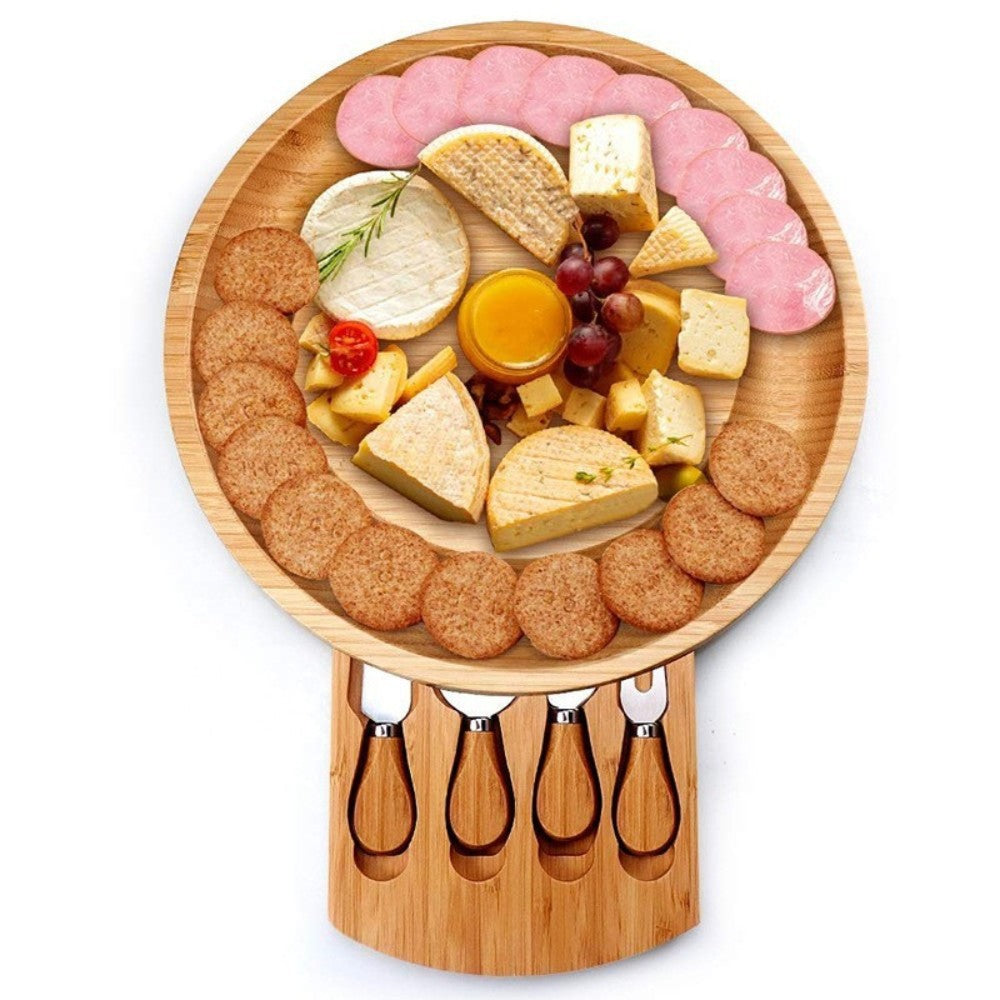 A bamboo and wood cheese board cheese board wooden round rotatable cutting board with drawer small bowl knife and fork set