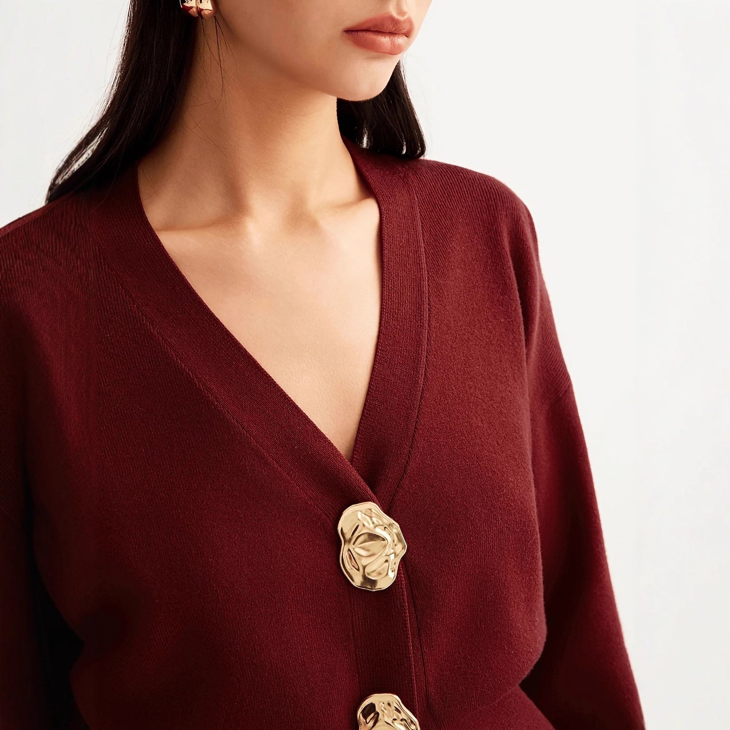 A button-down V-neck knitted sweater