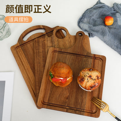 A Acacia wood pizza tray with handle solid wood cheese bread tray household steak plate, creative wooden small cutting board
