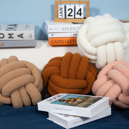 A braided knotted ball pillow