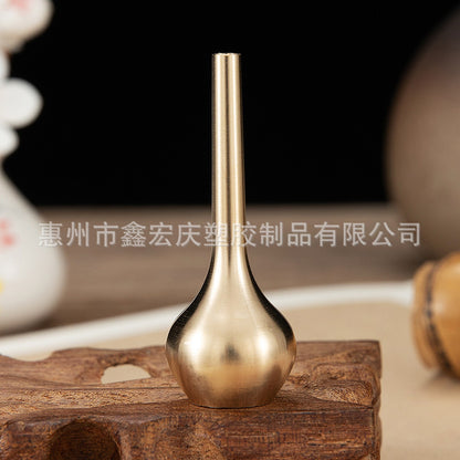 A brass mini vase ornament