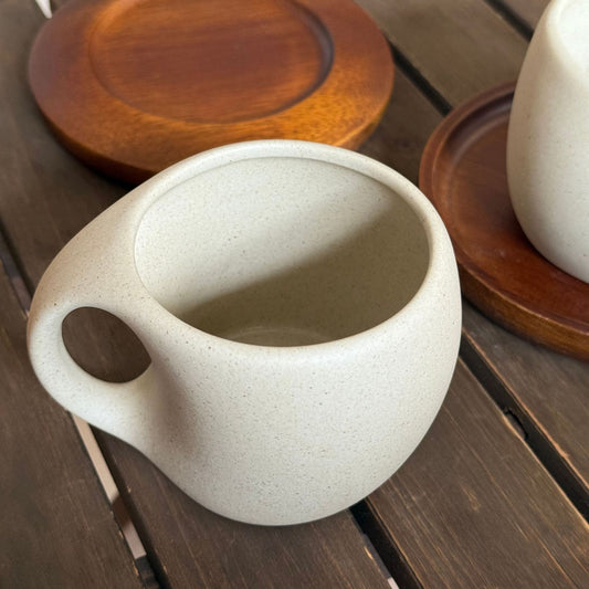 A ceramic coffee cup wooden saucer set