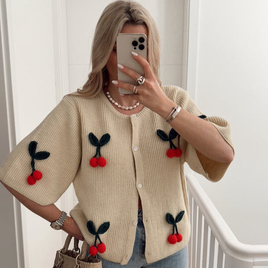 A cherry garnish sweater