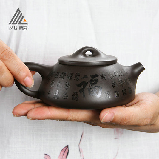 A purple clay pot teapot