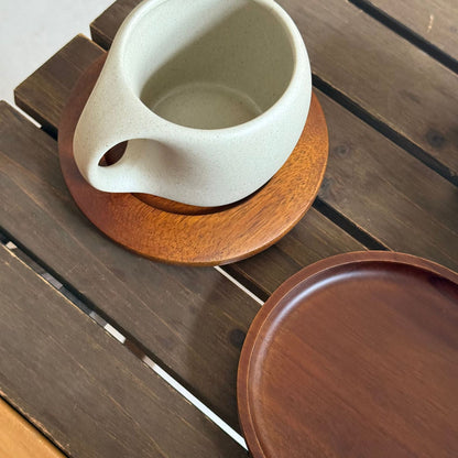 A ceramic coffee cup wooden saucer set