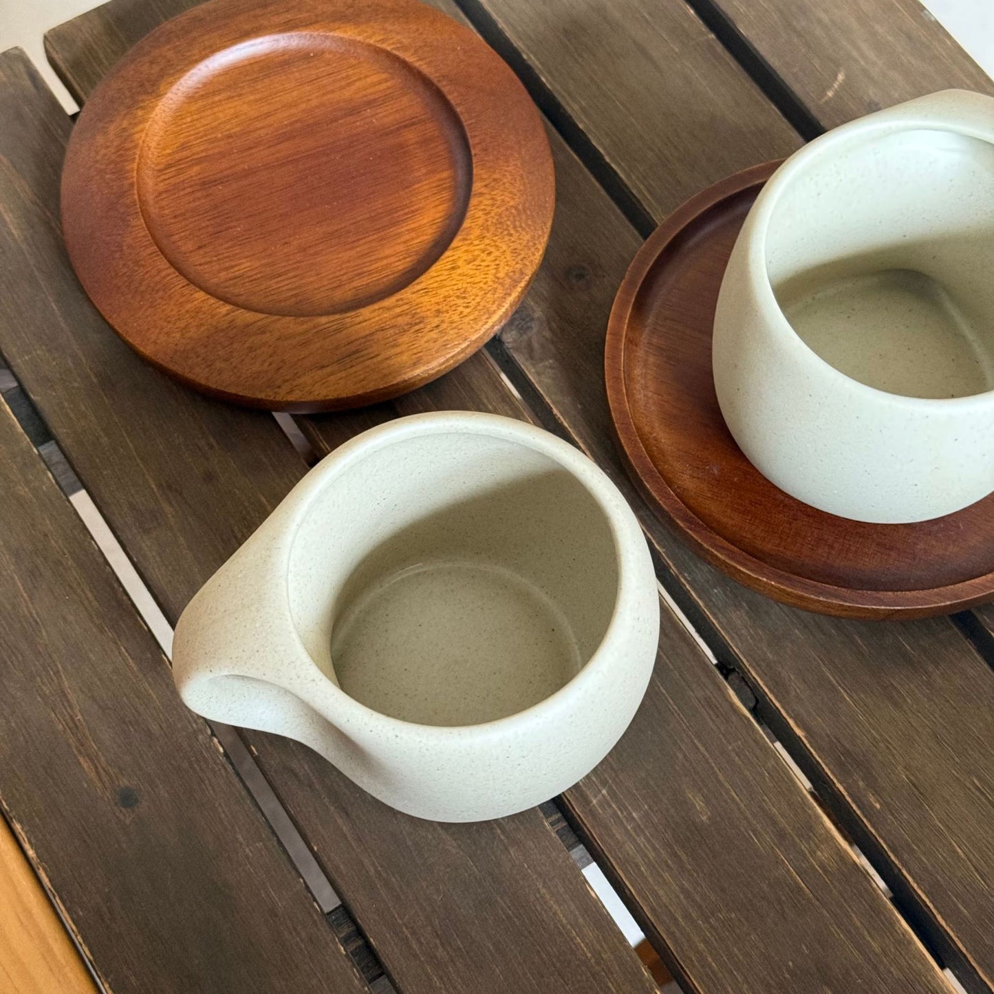 A ceramic coffee cup wooden saucer set