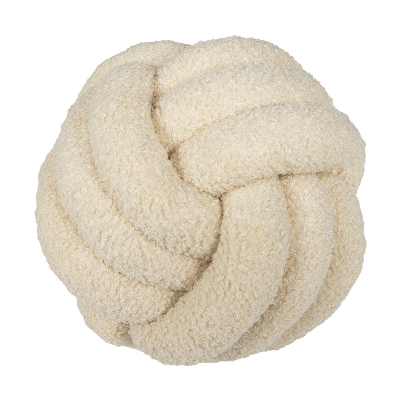 A braided knotted ball pillow