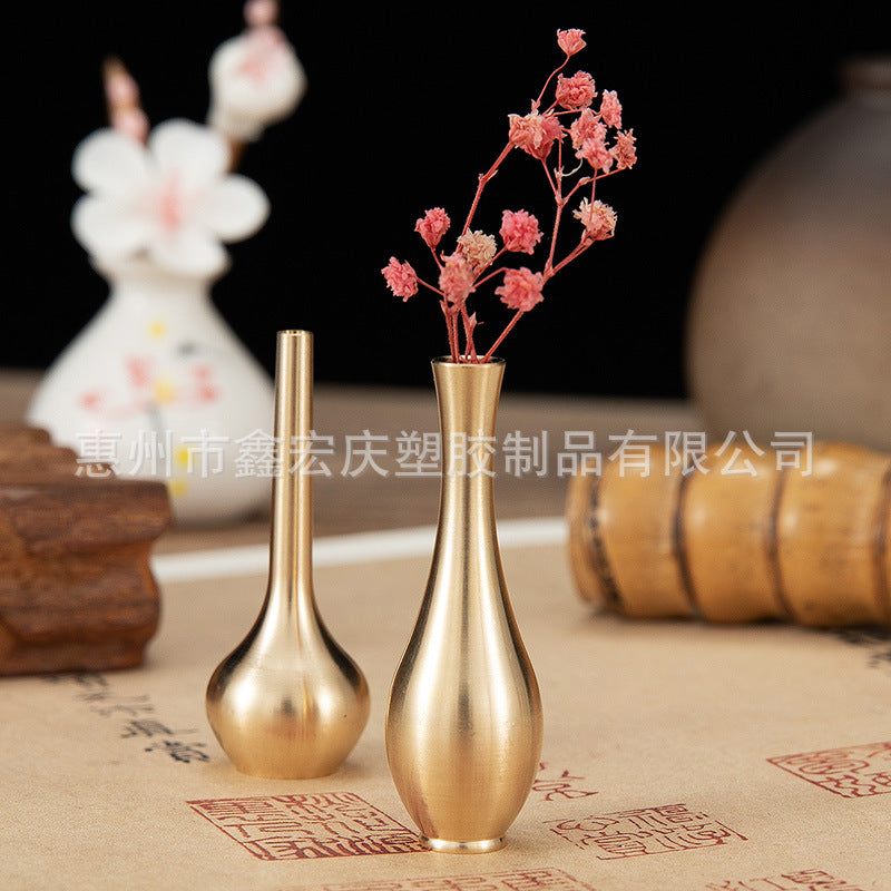 A brass mini vase ornament