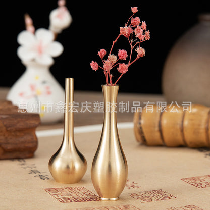 A brass mini vase ornament