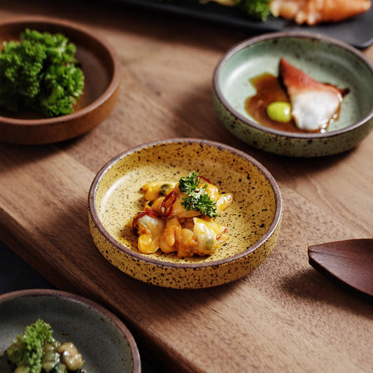 A rough pottery dipping sauce dish