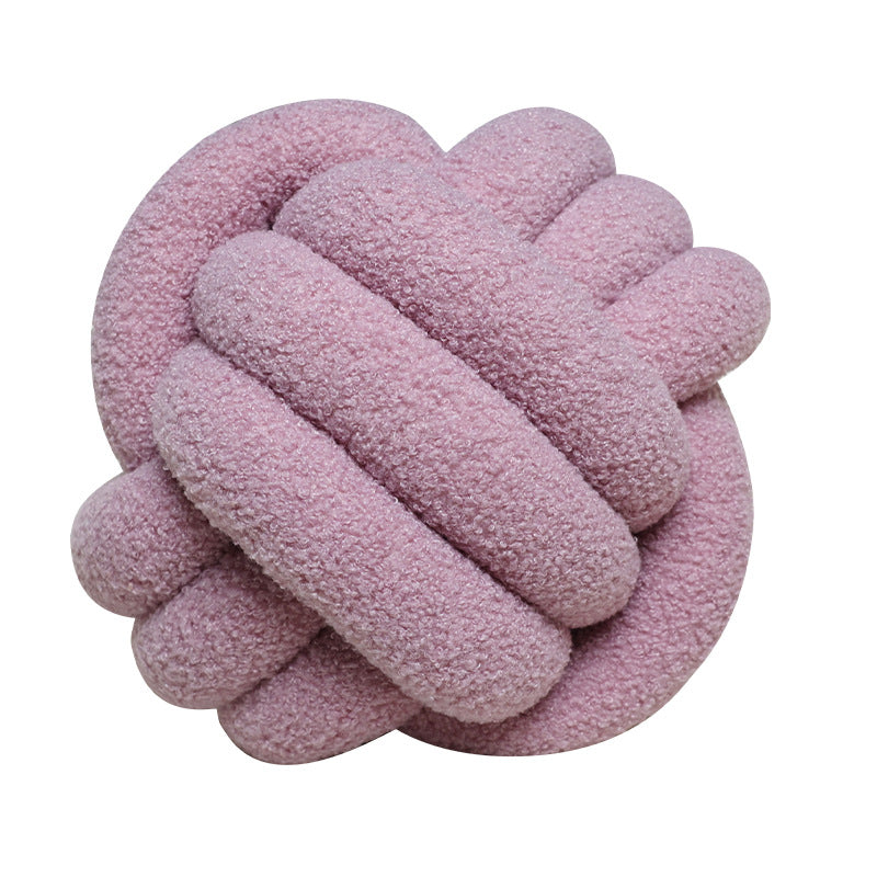 A braided knotted ball pillow