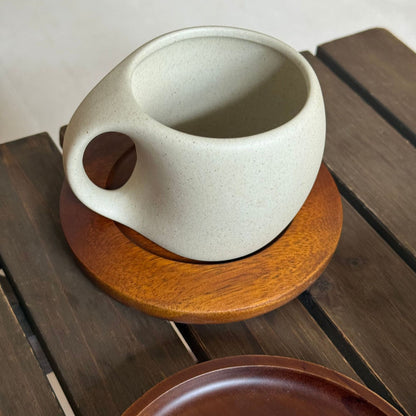 A ceramic coffee cup wooden saucer set